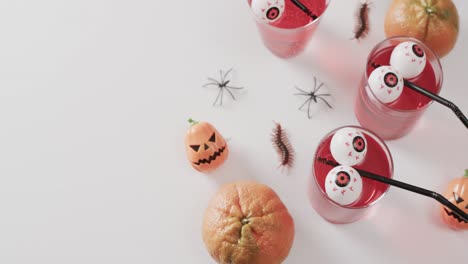 video of halloween drinks and decorations with copy space on white background