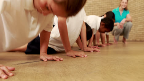 pupils doing push ups during sport lesson