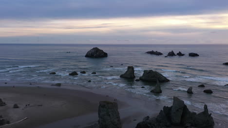 view of the coastline in bandon oregon with large sea stacks getting pounded by the waves - aerial pullback