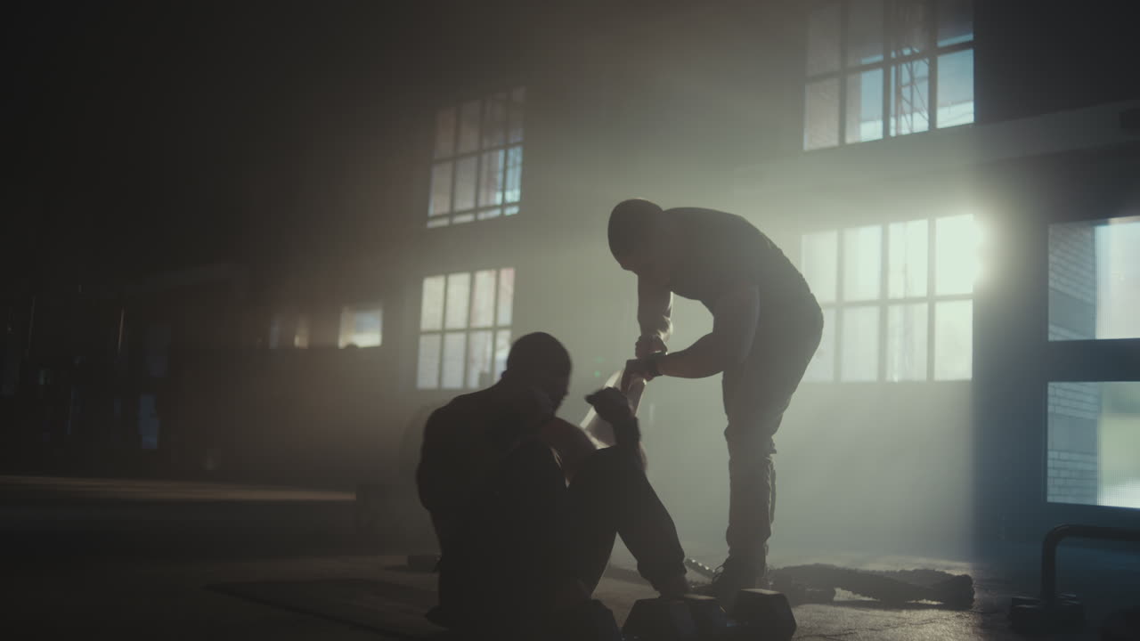 Man Doing Sit-ups with Trainer