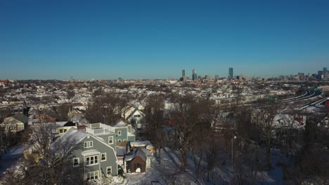 Crane-aerial-shot-revealing-city-skyline-during-winter