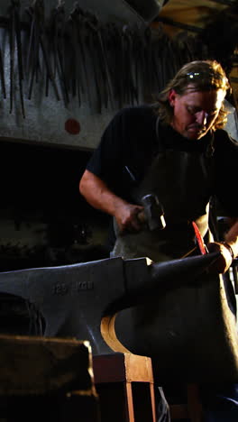 blacksmith working on a iron rod