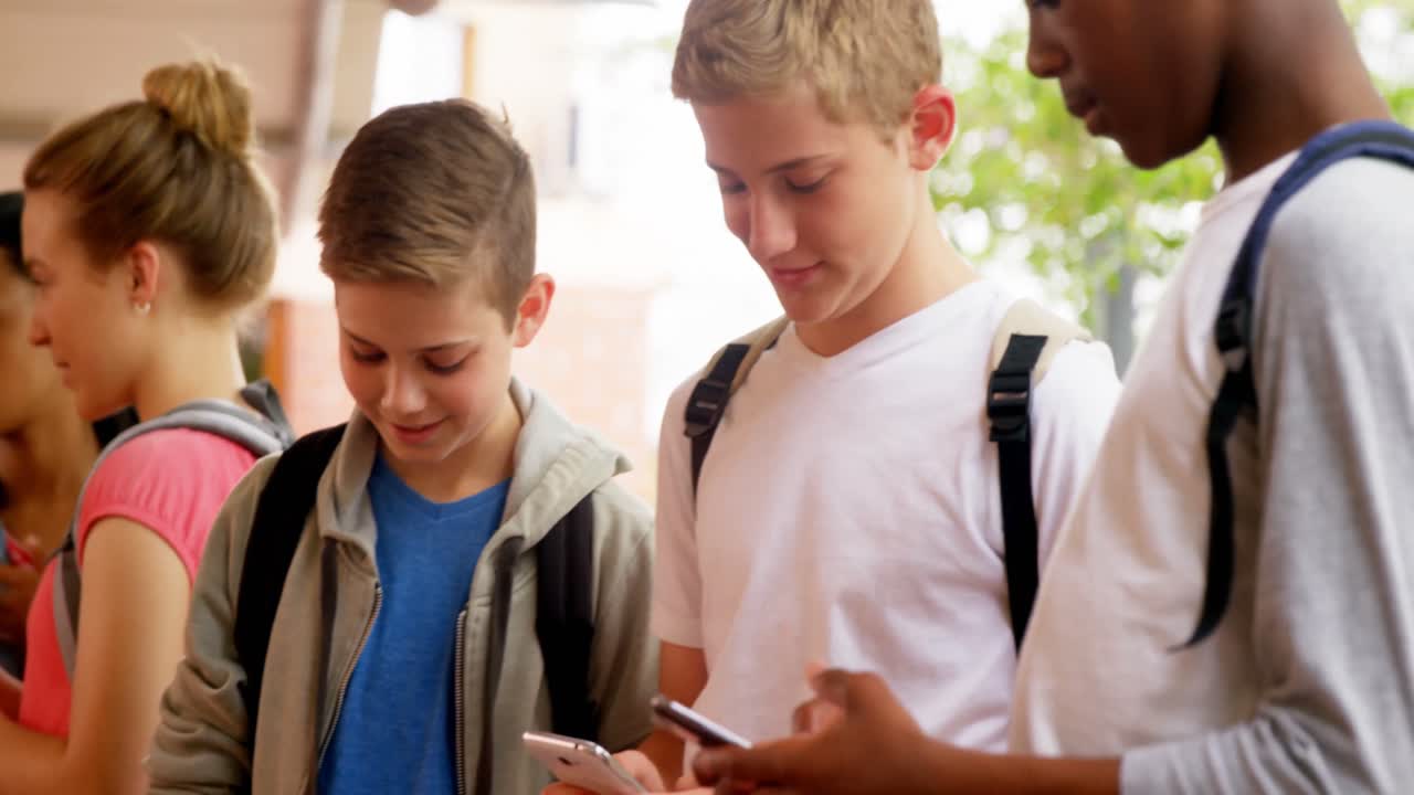 Group of school friends using mobile phone 4k