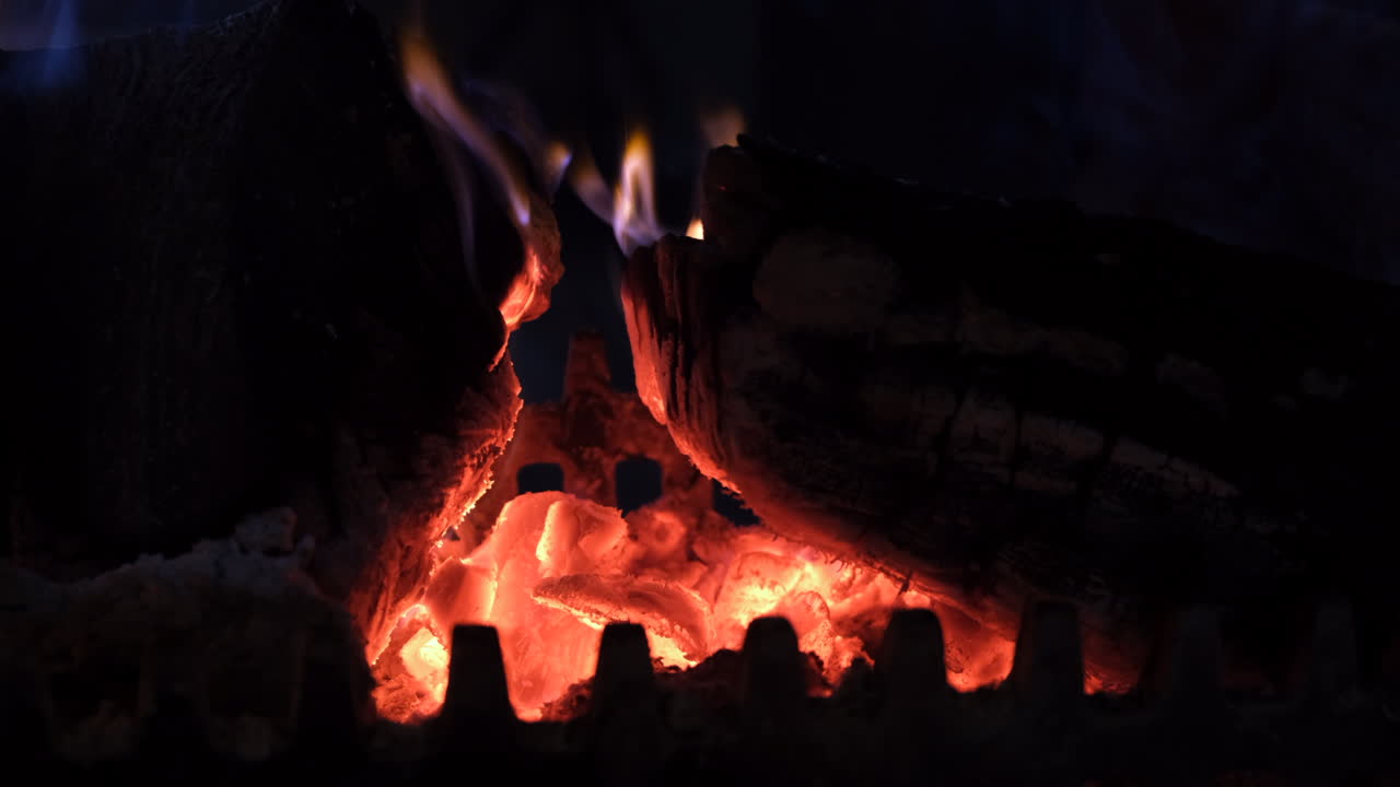 A glowing log fire burning in the fireplace of a house, Worcestershire, England.