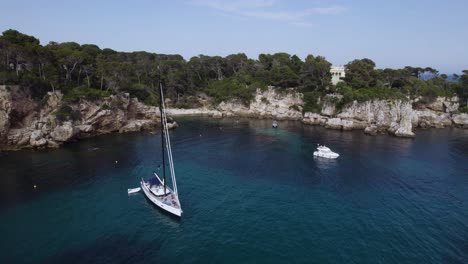 luxury yacht boat on south of france coastline, near antibes and cannes - aerial orbit