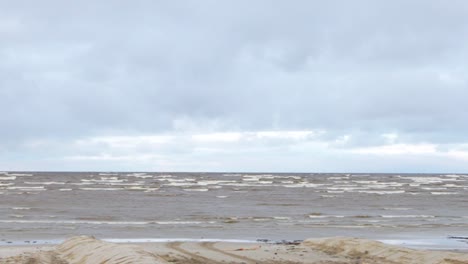 cloudy beach scene with gentle waves