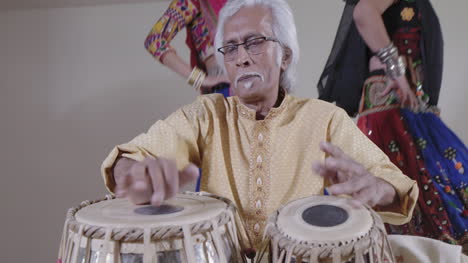 indian percussion musician with dancers 03