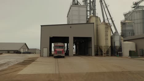 Drone-shot-of-a-semi-loading-feed-at-a-farm's-feed-mill-in-Minnesota