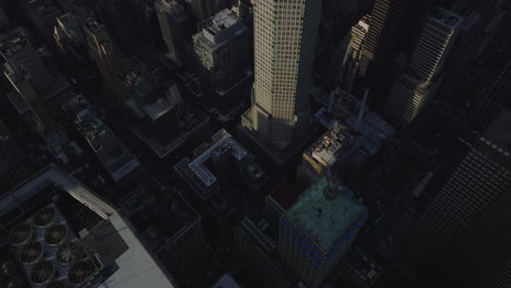 Fly-over-high-rise-buildings.-Tilt-down-to-regular-mesh-of-streets-between-building-blocks.-Manhattan,-New-York-City,-USA