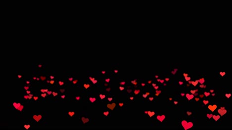 red hearts falling on black background