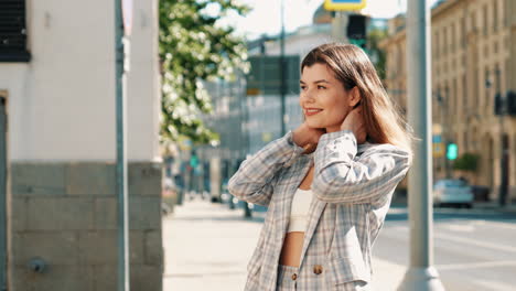 stylish woman in plaid blazer on city street