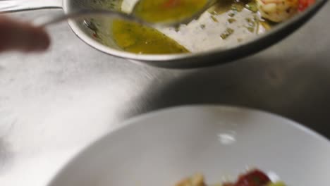 Close-up-professional-italian-chef-working-in-a-restaurant-kitchen-preparing-classic-Mediterranean-diet-pasta-tagliatelle-o-spaghetti-with-seafood