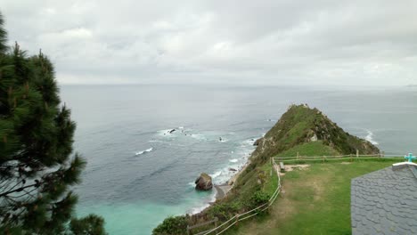 aerial dolly shot of ermita de la regalina, a small chapel on a cliff on the cantabrian sea, in the province of asturias in spain