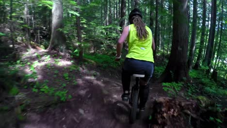 woman riding unicycle in the forest 4k