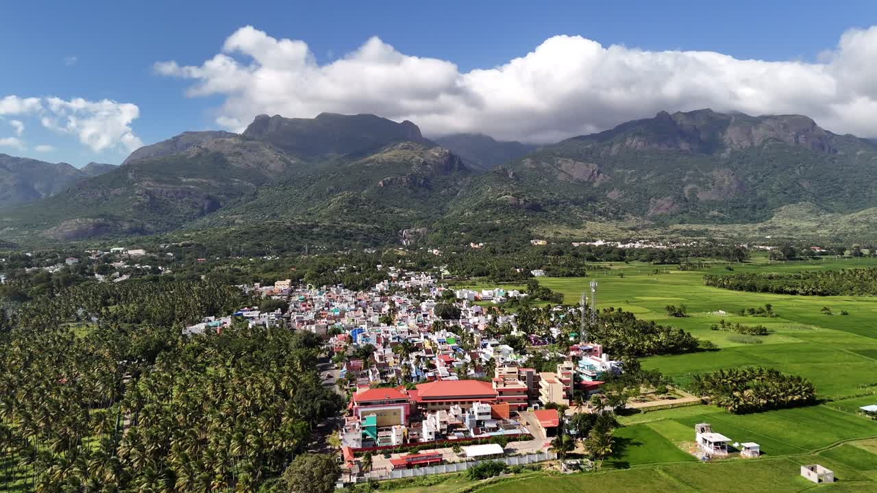 Aerial view of a serene South Indian hill station, showcasing temples, lush greenery, and the tranquil beauty of the Western Ghats
