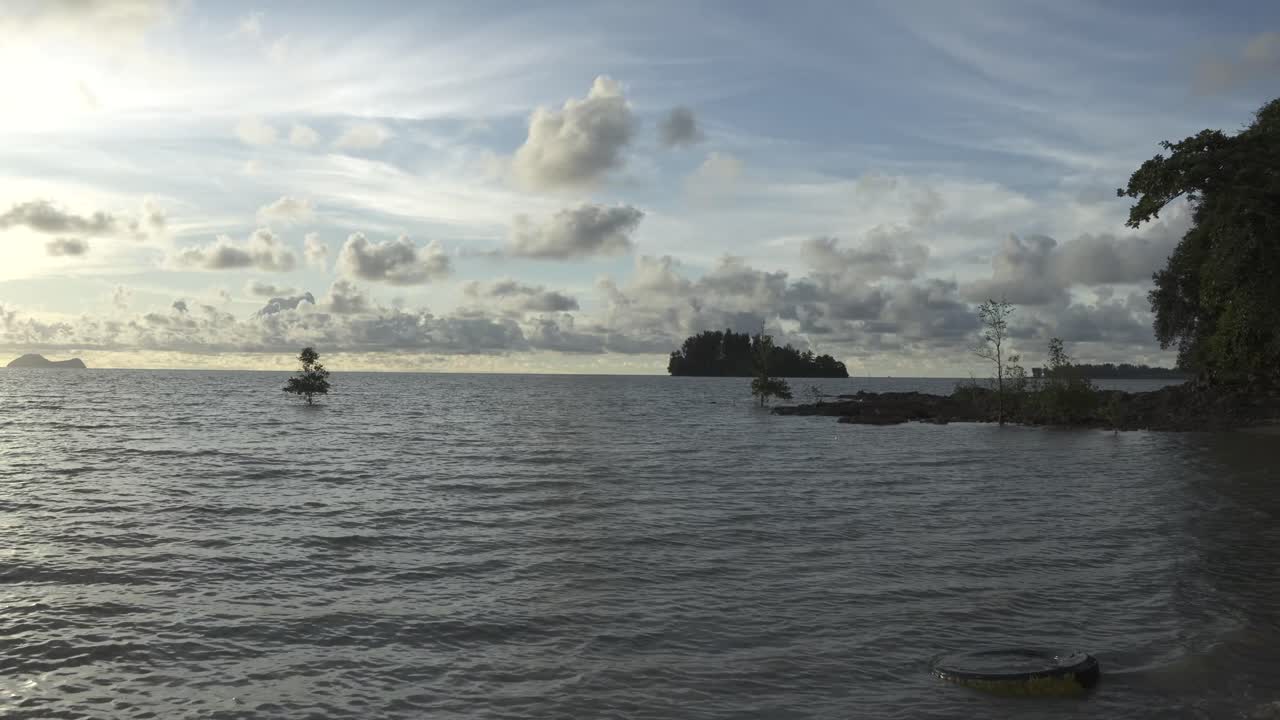 Summer At Pasir Pandak With Beautiful White Sandy Beach During Sunset Facing Wide Open Sea surrounded with Rock And Green Trees,Sarawak,Borneo.