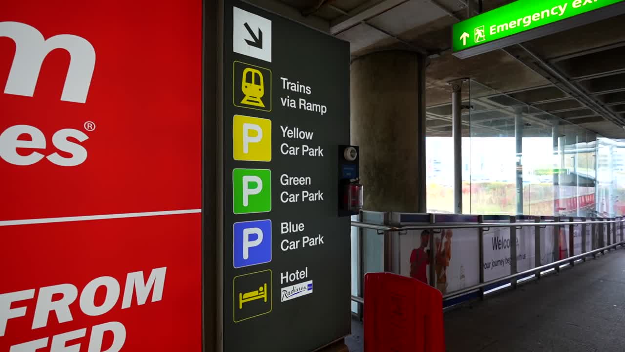 Stansted Airport directional signage for trains, parking, and hotel access in London