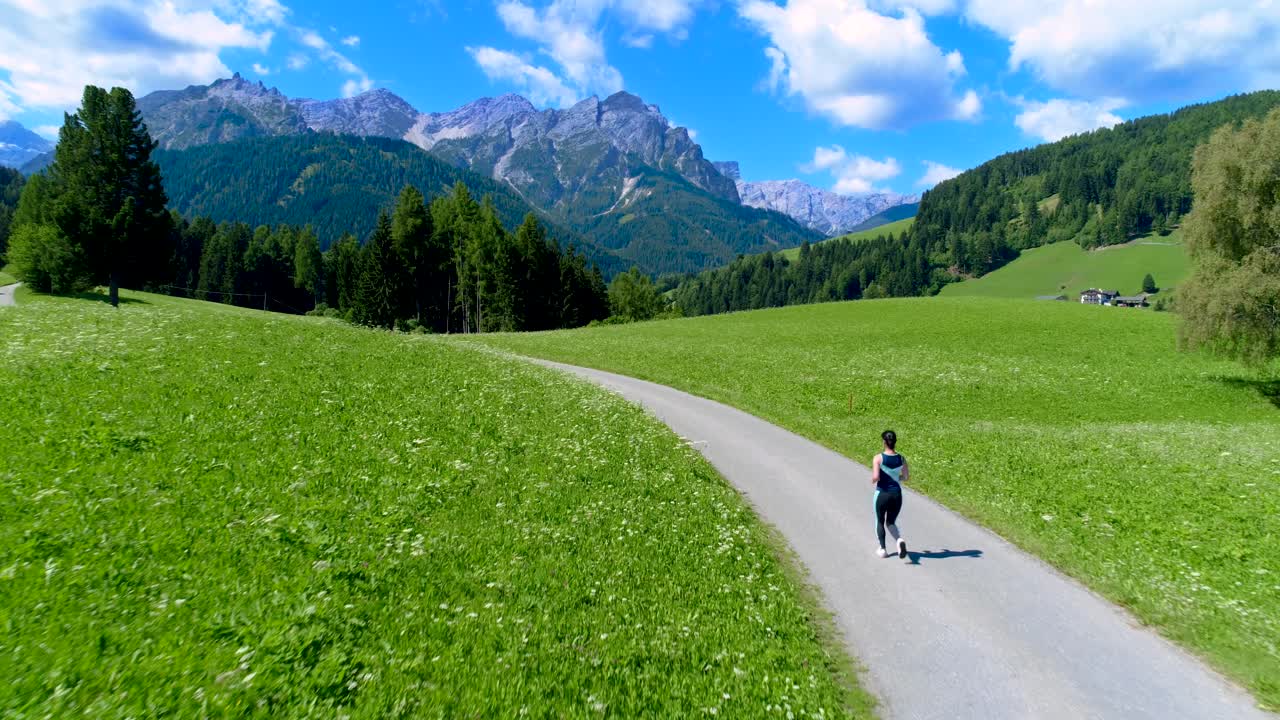Woman jogging outdoors. Italy Dolomites Alps
