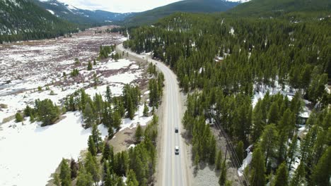 Jeep-wrangler-driving-towards-snowy-mountains,-solo-adventure-road-trip