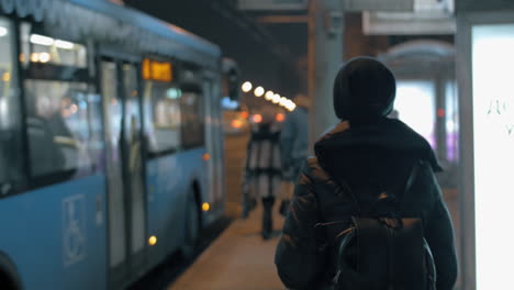 Woman-getting-on-the-bus-arrived-at-the-public-transport-stop