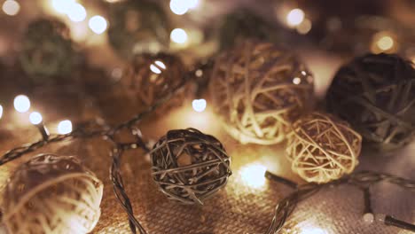 close-up christmas garland and handmade balls on a playd with golden lights. christmas concept. home decor