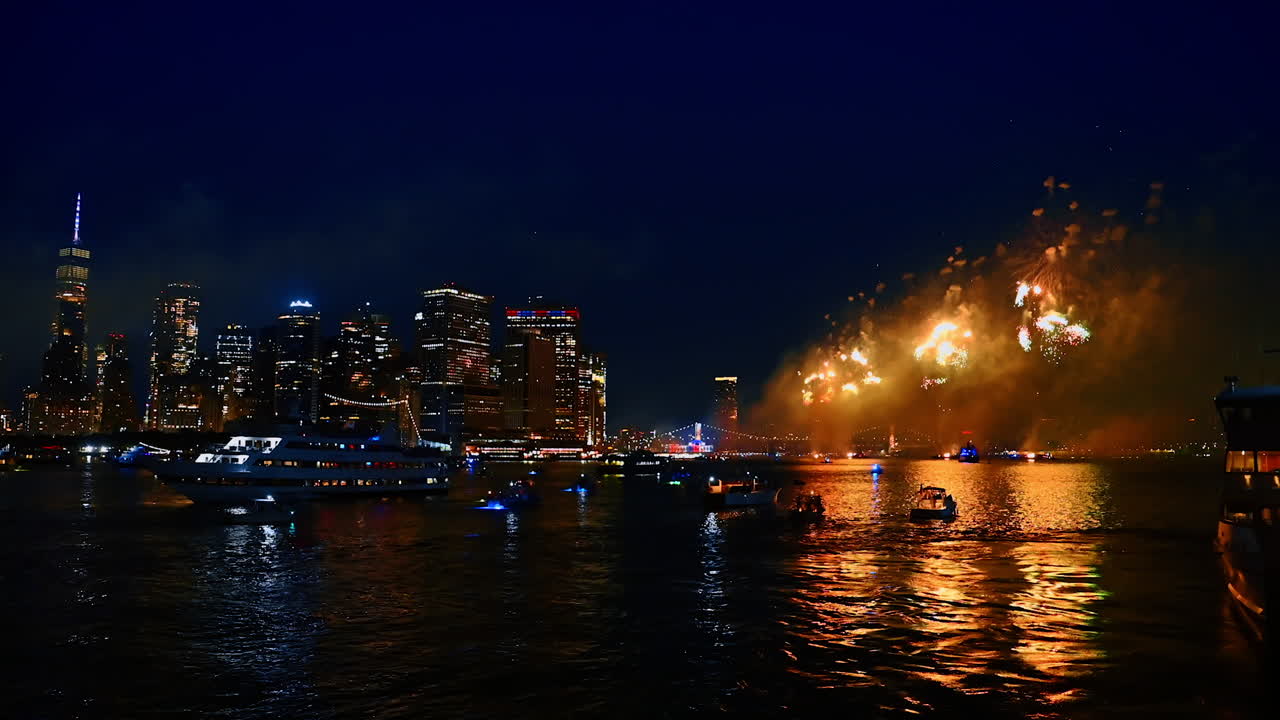 Numerous boats gathered on the waterscape to watch fantastic fireworks. Celebration of the 4th July in New York, USA
