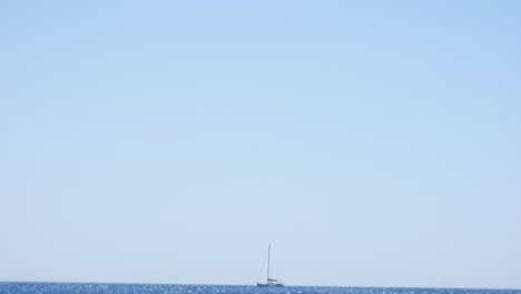 sailboat lost and alone in the mediterranean ocean after departing santorini island in greece