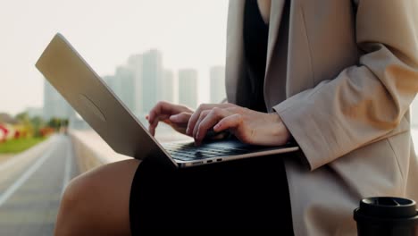 businesswoman working on a laptop outdoors