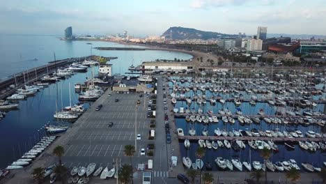 Peaceful-morning-look-over-the-olympic-harbor-of-Barcelona,-aerial-pull-in