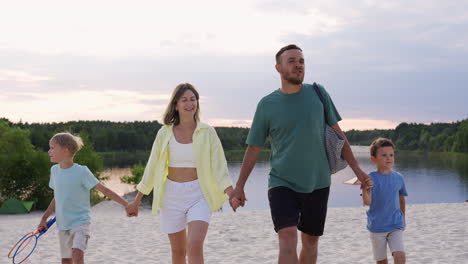 family holding hands on the beach