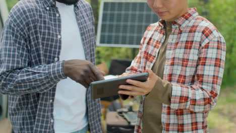 ecologists watching data on tablet