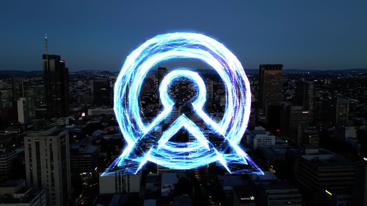 Captivating Digital Projection of a Vibrant Blue Logo Illuminating the Cityscape at Dusk, Creating a Stunning Visual Contrast Against the Urban Backdrop