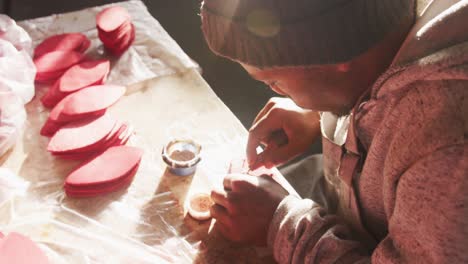 side view of man working by hand in factory