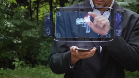 Businessman uses hologram with gun