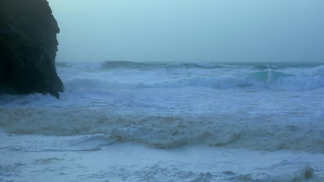 the violent waves in chapel porth beach, uk during storm ciara - slow motion