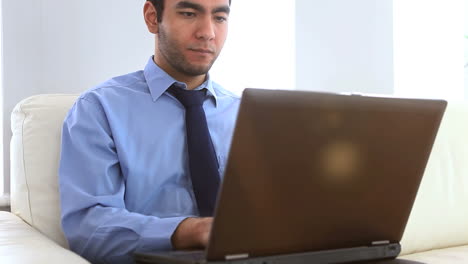 businessman using a laptop on a couch