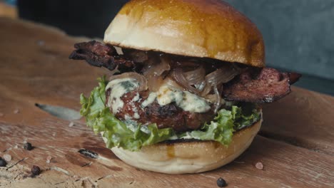 delicious blue cheese bacon burger on a wooden board