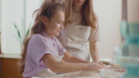 mother and daughter preparing the dough