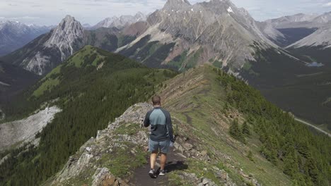 Hiker-walking-down-the-ridge-Rockies-Kananaskis-Alberta-Canada