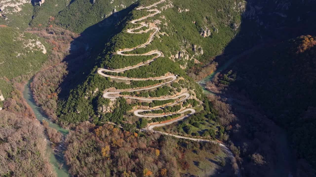 Aerial perspective of remote road snaking through forested hills