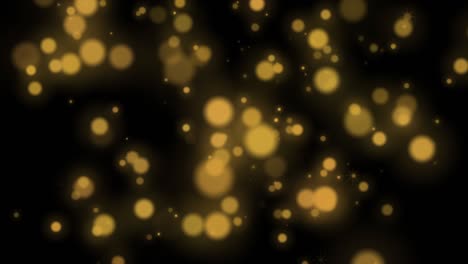 las partículas de color dorado desfocalizadas de fondo 4k
