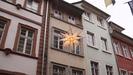 shining star decoration in market street of heidelberg at a festive christmas market in europe