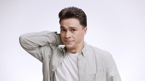 man with neutral expression, slightly uncomfortable