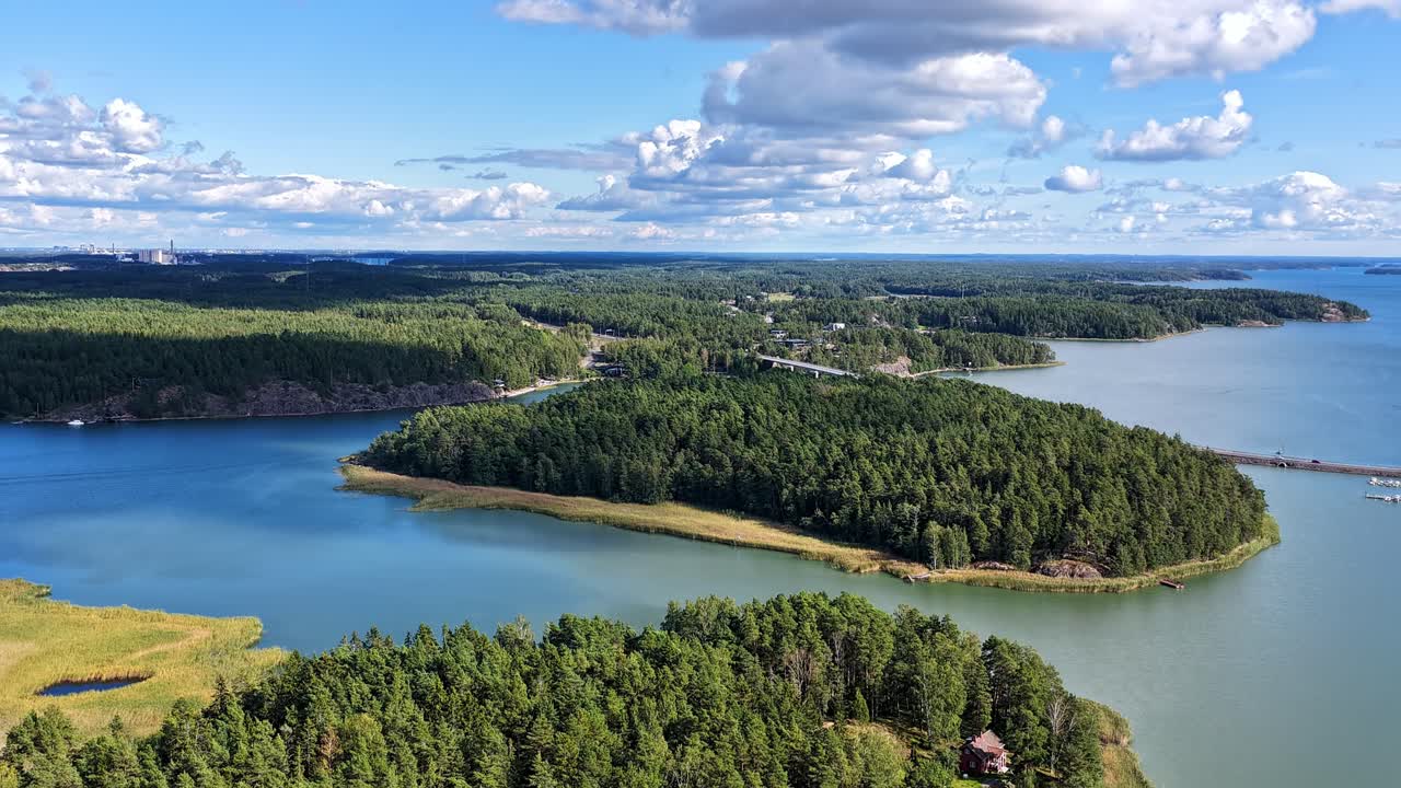 Drone hyperlapse over Finnish Turku Archipelago Sea. Sunny summer weather. Clouds and shadows moving over the scenery. High altitude moving aerial view