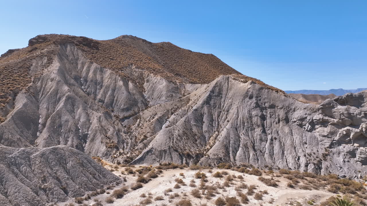 Close up aerial to the heavily eroded sedimentary rock hillsides Tabernas Desert