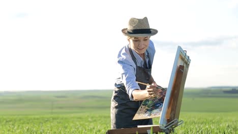 girl artist paints a picture with oil paints