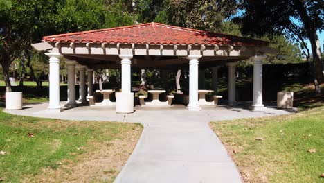 Aerial-crane-shot-rising-over-a-park-gazebo