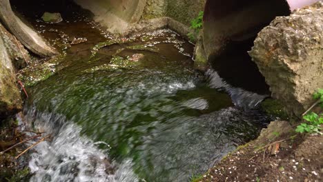 water flows out of the pipe into the gutter 02