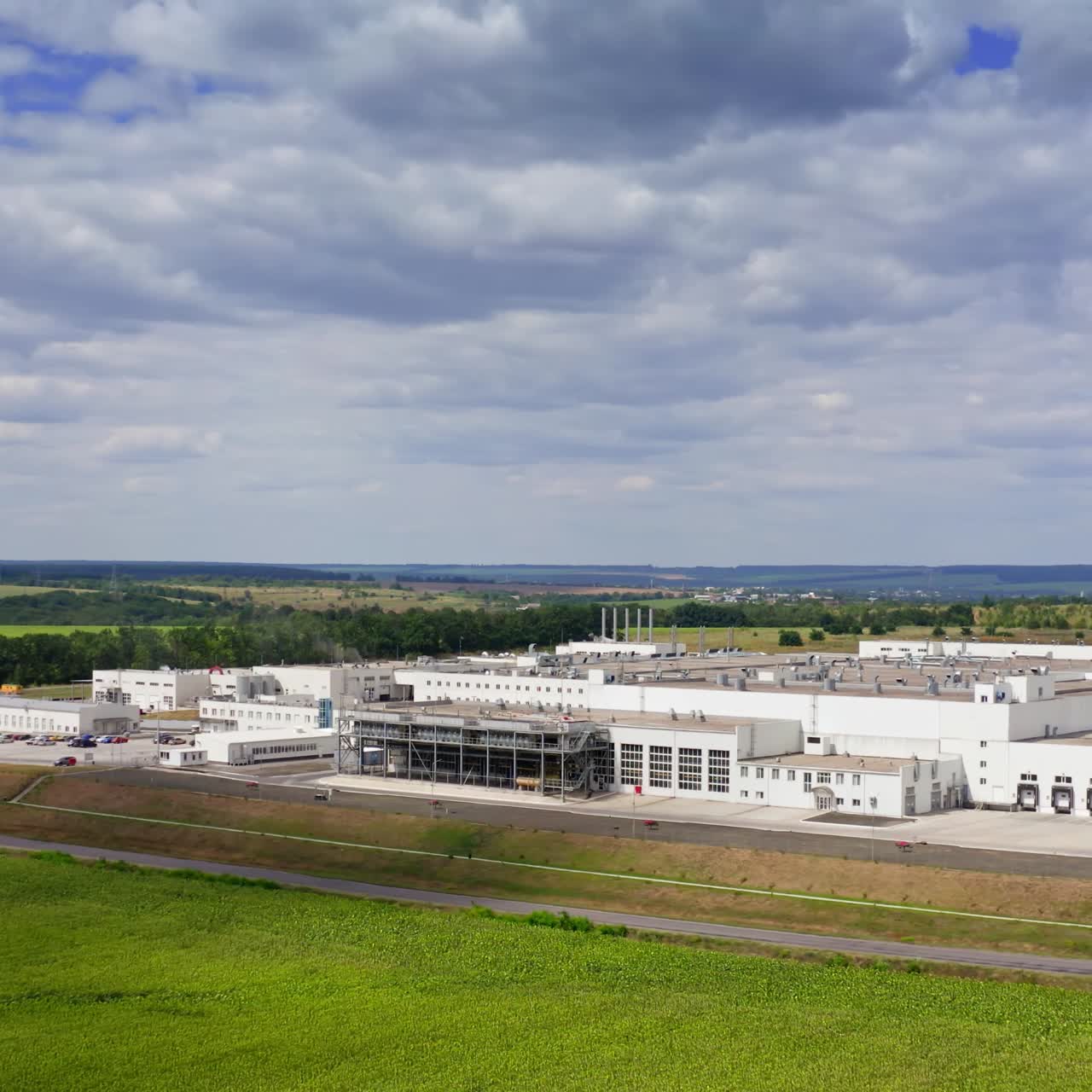 A modern factory in the process of building. Aerial view of stylized altered generic modern industrial building