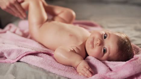 mother's hands massage the feet of a little baby girl